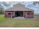 Exterior shot of the horse barn featuring stalls and open storage area at 31707 Orange St, Sorrento, FL 32776