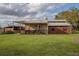 View of tan barn with shed roof in fenced area, complete with riding equipment at 31707 Orange St, Sorrento, FL 32776