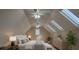 Bright bedroom features two ceiling fans, skylights and window with plantation shutters for natural light at 31707 Orange St, Sorrento, FL 32776