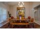 Elegant dining room featuring a wooden table with bench seating, a patterned rug, and stylish decor at 31707 Orange St, Sorrento, FL 32776