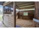 An interior view of a horse stall complete with wood plank walls and bars at 31707 Orange St, Sorrento, FL 32776