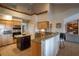 Well-lit kitchen with wooden cabinets, stainless steel appliances, and a granite countertop bar at 31707 Orange St, Sorrento, FL 32776