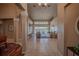 Open-concept living room with tiled floors, large windows, and a view of the outdoor lounge area at 31707 Orange St, Sorrento, FL 32776