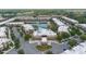 Aerial view of a condo community with lake, pool, clubhouse, and lush greenery at 3191 Brasilia Ave, Kissimmee, FL 34747