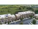 Aerial view of a community with modern condos, parking lots, and green spaces at 3191 Brasilia Ave, Kissimmee, FL 34747