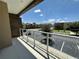 Spacious balcony offering views of the community and parking area, perfect for relaxing and enjoying the outdoors at 3191 Brasilia Ave, Kissimmee, FL 34747