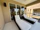 Balcony with two lounge chairs and views of green landscape at 3191 Brasilia Ave, Kissimmee, FL 34747