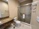 Modern bathroom featuring a granite vanity, sleek fixtures, and a glass-enclosed shower for a luxurious experience at 3191 Brasilia Ave, Kissimmee, FL 34747