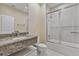 Modern bathroom with granite countertop, stylish fixtures, and glass-enclosed shower at 3191 Brasilia Ave, Kissimmee, FL 34747