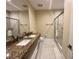 Contemporary bathroom featuring granite countertops, double sinks, white tile and glass shower at 3191 Brasilia Ave, Kissimmee, FL 34747