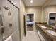 Bathroom showing double vanity, stone countertops, shower with glass doors and bedroom view at 3191 Brasilia Ave, Kissimmee, FL 34747
