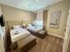 Bright bedroom featuring two twin beds with upholstered headboards and stylish decor, creating a welcoming and comfortable space at 3191 Brasilia Ave, Kissimmee, FL 34747