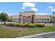 Clubhouse entrance featuring modern architecture, landscaping, and signage at 3191 Brasilia Ave, Kissimmee, FL 34747