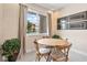 Cozy dining area with a round wooden table and natural light at 3191 Brasilia Ave, Kissimmee, FL 34747