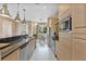 Modern kitchen with stainless steel appliances and a view to the dining room at 3191 Brasilia Ave, Kissimmee, FL 34747