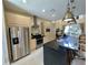 Open kitchen featuring granite countertops, stainless steel appliances, and bar seating at 3191 Brasilia Ave, Kissimmee, FL 34747