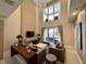 Bright living room boasts high ceilings, a modern chandelier, and sliding glass doors to the patio at 3191 Brasilia Ave, Kissimmee, FL 34747