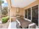 Cozy outdoor kitchen with a built-in grill, granite countertops, and a comfortable dining area, perfect for entertaining at 3191 Brasilia Ave, Kissimmee, FL 34747