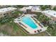 Aerial view of a community pool with lounge chairs and palm trees at 3191 Brasilia Ave, Kissimmee, FL 34747