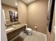 Small powder room with granite countertop, modern fixtures and decorative artwork at 3191 Brasilia Ave, Kissimmee, FL 34747