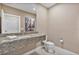 Stylish powder room featuring granite countertop, modern fixtures, and decorative wall art at 3191 Brasilia Ave, Kissimmee, FL 34747