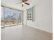 Bright bedroom featuring large windows with city views and light wood-look flooring, enhanced by a ceiling fan at 322 E Central Blvd # 606, Orlando, FL 32801