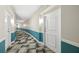 Hallway with neutral paint, contrasting trim, and patterned carpet provides a clean, stylish walkway at 322 E Central Blvd # 606, Orlando, FL 32801