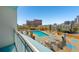 Relaxing pool area surrounded by lounge chairs, lush greenery, and views of the city skyline at 322 E Central Blvd # 606, Orlando, FL 32801