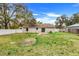 Exterior view of the home showcasing the spacious backyard with lush green grass and privacy fence at 3357 Shalimar Cir, Deltona, FL 32738