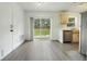 Efficient kitchen with sliding glass doors to the backyard, white walls, and vinyl flooring at 3357 Shalimar Cir, Deltona, FL 32738