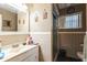 Bathroom featuring tiled walls, vanity, mirror, toilet, and glass shower stall at 3708 Pipes O The Glen Way, Orlando, FL 32808