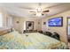 Bedroom featuring a bed, ceiling fan, and a wall-mounted television at 3708 Pipes O The Glen Way, Orlando, FL 32808