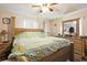 Bedroom with a large bed, wooden furniture, and decorative accents at 3708 Pipes O The Glen Way, Orlando, FL 32808