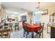 Open dining area with tile flooring, breakfast bar, and a view into the kitchen at 3708 Pipes O The Glen Way, Orlando, FL 32808