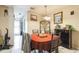 Comfortable dining room with tile flooring, a red tablecloth, and view into the entry hallway at 3708 Pipes O The Glen Way, Orlando, FL 32808