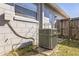 Exterior shot of the home's AC unit and fenced in area next to the building at 3708 Pipes O The Glen Way, Orlando, FL 32808