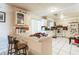 Bright kitchen with tile backsplash, white cabinetry, and a breakfast bar at 3708 Pipes O The Glen Way, Orlando, FL 32808