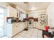 Bright kitchen featuring white appliances and cabinets, contrasted by red and white tiles at 3708 Pipes O The Glen Way, Orlando, FL 32808