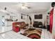 A cozy living room with a couch, TV, and decorative rug adjacent to the kitchen at 3708 Pipes O The Glen Way, Orlando, FL 32808