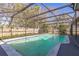 A beautifully screened-in pool surrounded by a well-maintained patio area at 3708 Pipes O The Glen Way, Orlando, FL 32808