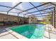 View of inground pool with screened enclosure, patio area, and view of backyard at 3708 Pipes O The Glen Way, Orlando, FL 32808