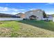 Wide shot of a well-maintained backyard with a gazebo, grill, and green grass at 4655 Ross Lanier Ln, Kissimmee, FL 34758