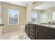 Bright bathroom featuring double vanity with granite countertops and large mirror at 4655 Ross Lanier Ln, Kissimmee, FL 34758