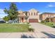 Charming two-story home featuring a well-manicured lawn, inviting orange door, and an attached garage at 4655 Ross Lanier Ln, Kissimmee, FL 34758