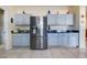 Modern kitchen with stainless steel refrigerator and matching gray cabinets at 4655 Ross Lanier Ln, Kissimmee, FL 34758