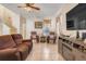 Bright living room featuring tile floors, a ceiling fan, a large TV, and comfortable seating at 4655 Ross Lanier Ln, Kissimmee, FL 34758