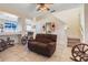 Spacious living room featuring tile floors, a ceiling fan, comfortable seating, and an open layout at 4655 Ross Lanier Ln, Kissimmee, FL 34758