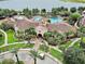 Aerial view of resort with multiple pools, lush landscaping, and a serene lake backdrop at 4814 Cayview Ave # 407, Orlando, FL 32819