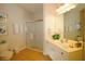 Bathroom featuring a glass-enclosed shower, white vanity, and decorative elements at 4814 Cayview Ave # 407, Orlando, FL 32819