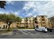 Exterior of a light yellow building with balconies, palm trees, and a parking lot in front at 4814 Cayview Ave # 407, Orlando, FL 32819